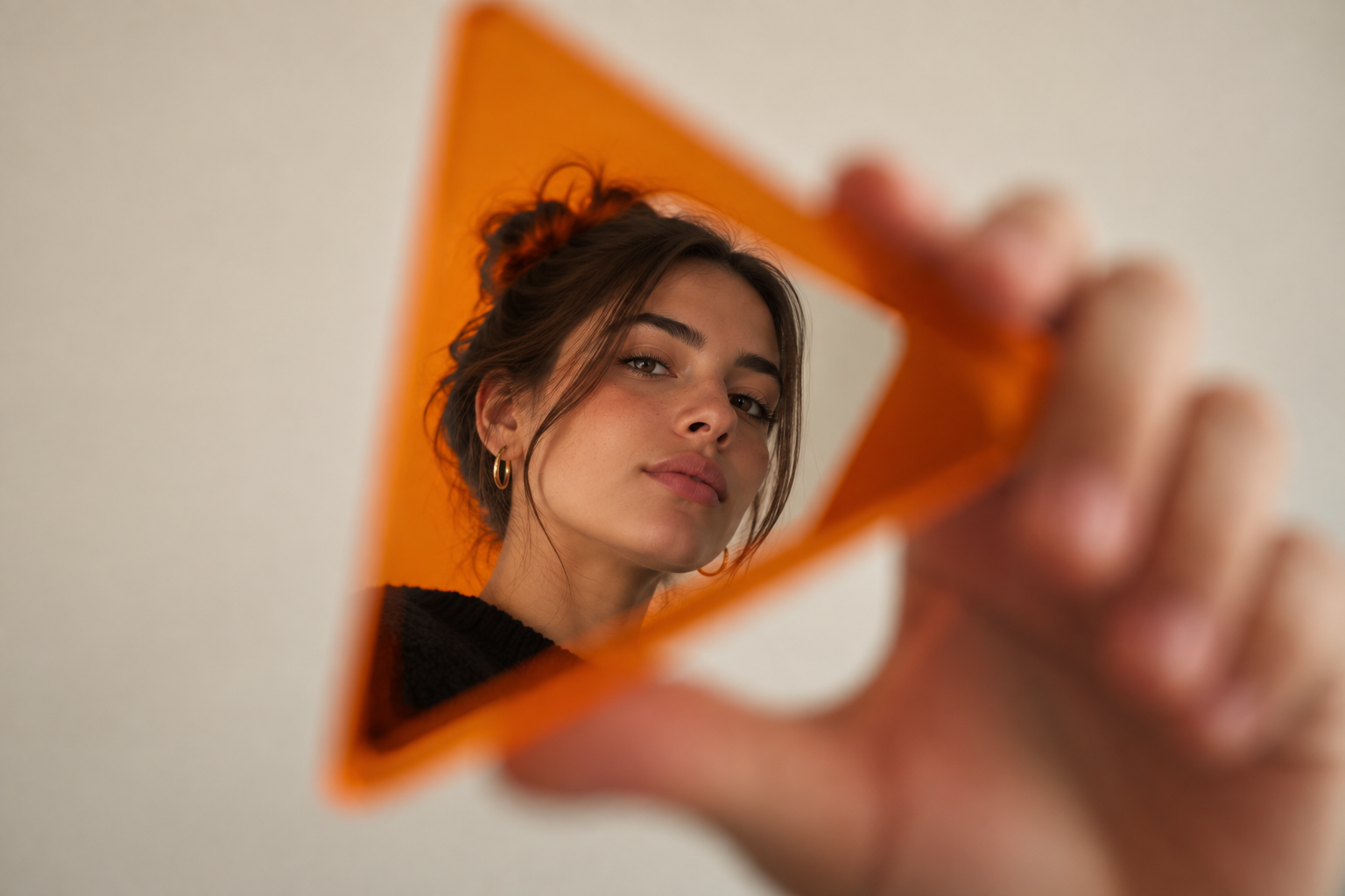 A portrait framed through a slab of orange acrylic